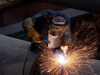 Man working on metal in factory