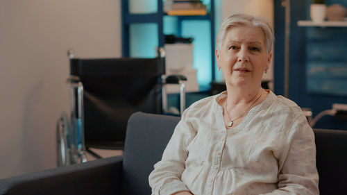 Portrait of senior woman sitting on sofa