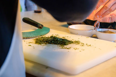Close-up of person preparing food on table