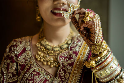 Midsection of woman with henna tattoo