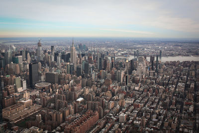 High angle view of modern buildings in city against sky