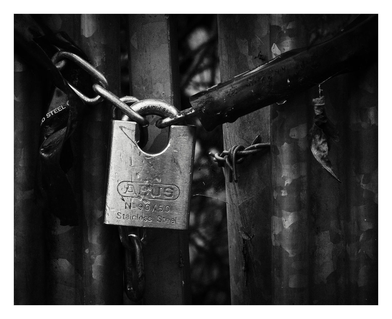 CLOSE-UP OF LOVE PADLOCKS HANGING ON METAL