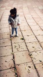 High angle view of girl standing on footpath