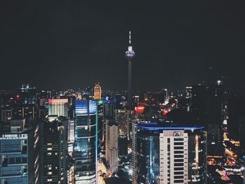 Aerial view of city lit up at night