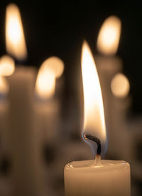 Close-up of lit candles in temple