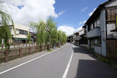 Empty road along houses