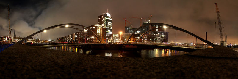 Suspension bridge over river at night