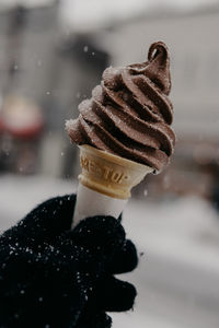 Close-up of hand holding ice cream cone