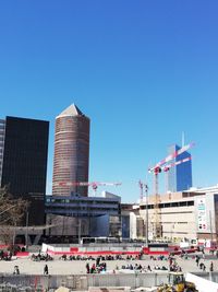 Buildings in city against blue sky