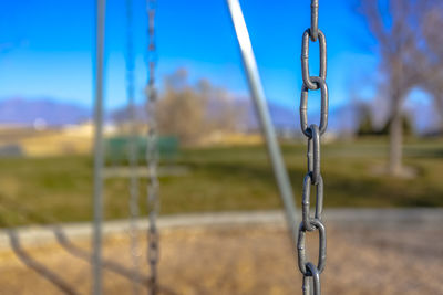 Close-up of swing chain on field