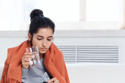 Portrait of beautiful woman drinking water