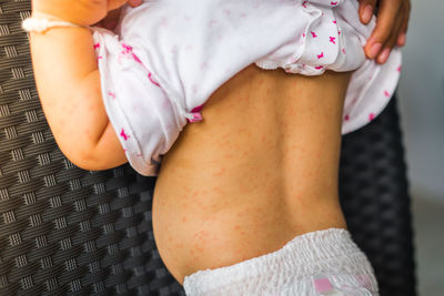 Midsection of woman at home