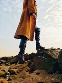 Low section of man standing on rock