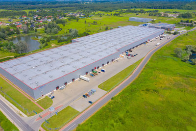 Aerial top view of the large logistics park with warehouse, loading hub with many semi-trailers .
