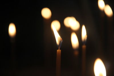 Close-up of lit candles in temple