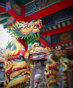 Low angle view of statue in temple against building