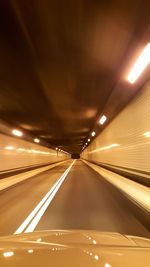 Illuminated tunnel at night