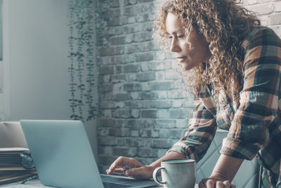 Young woman using laptop at home