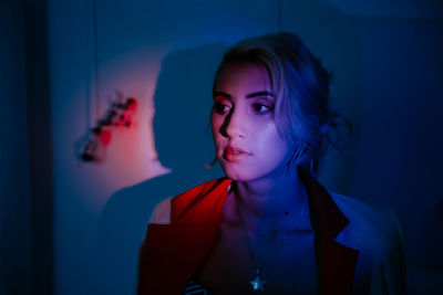 Close-up of beautiful young woman in darkroom