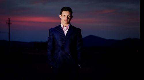 Portrait of man standing against sky at night