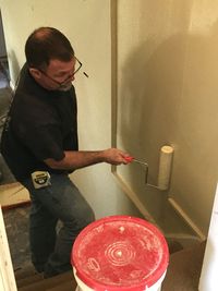 Man holding ice cream at home