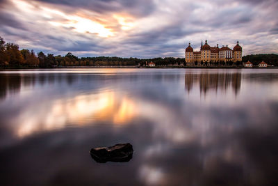 Reflection of building in lake at sunset