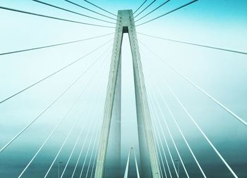 Low angle view of suspension bridge against sky