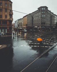 People on wet street in rainy season