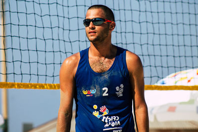 Portrait of young man wearing sunglasses standing outdoors