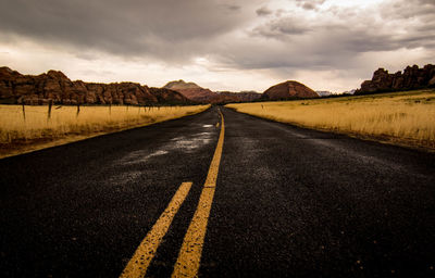 Road amidst landscape against sky