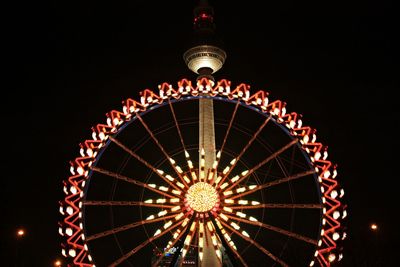 Low angle view of ferris wheel against sky at night