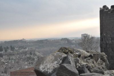 Buildings in city against sky during winter