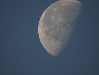 Low angle view of moon against blue sky