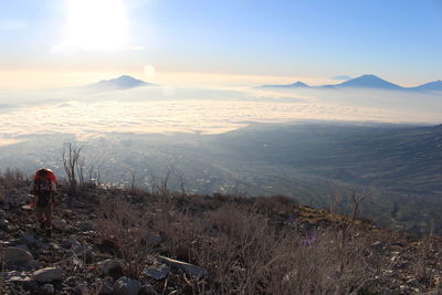 Hiker on mountain against sky