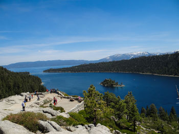 Scenic view of lake and mountains against blue sky