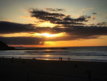 Scenic view of beach against sky during sunset