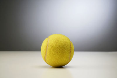 Close-up of yellow ball on table