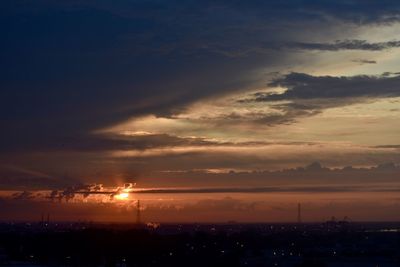 Silhouette city against sky during sunset