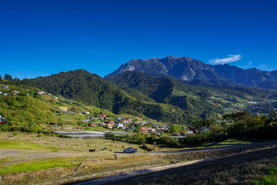 Scenic view of mountains against clear blue sky