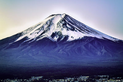 Scenic view of snowcapped mountain against blue sky