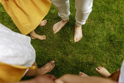 Feet of parents and children on grass