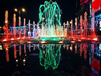 Reflection of illuminated buildings in lake at night