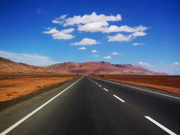 Empty road along countryside landscape