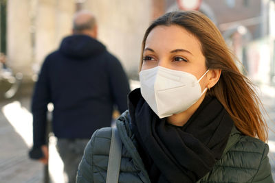 Woman wearing mask looking away