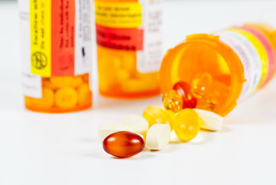 Close-up of orange bottle on white background