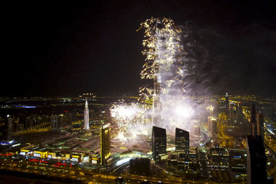 Firework display over city at night