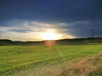 Scenic view of field against sky during sunset