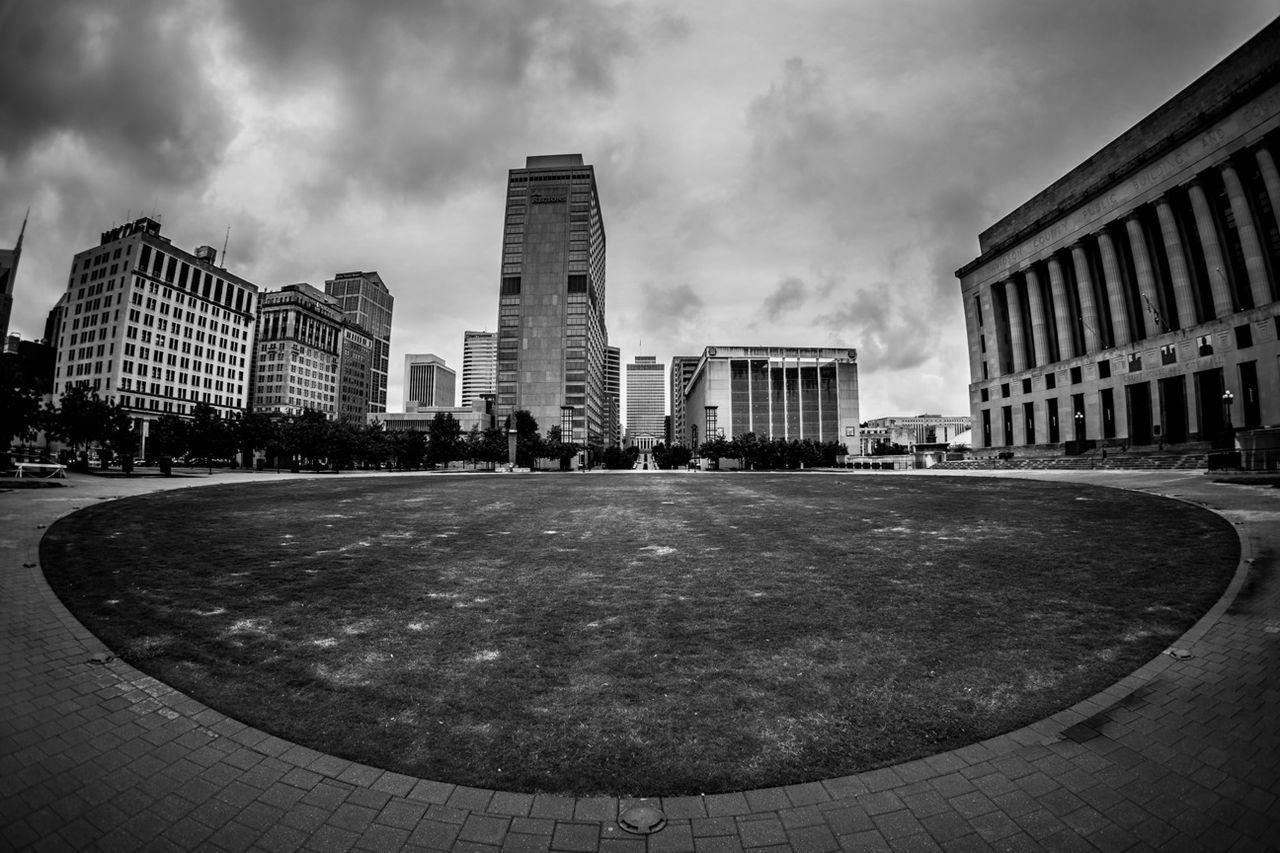 building exterior, architecture, built structure, sky, city, cloud - sky, cloudy, cloud, city life, building, modern, incidental people, office building, grass, men, day, cityscape, street, outdoors