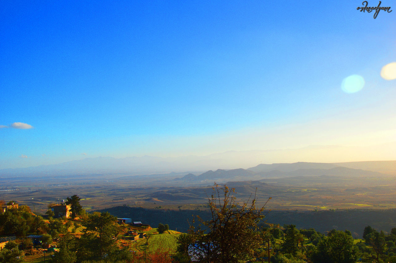 tranquil scene, scenics, tranquility, mountain, beauty in nature, nature, blue, clear sky, landscape, sky, copy space, mountain range, idyllic, sunset, plant, growth, non-urban scene, outdoors, tree, no people