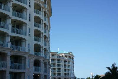 Low angle view of buildings against clear blue sky